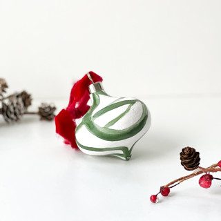This is a green holiday decorations by Mary Gaspar called green plant cell ornament with red ribbon in standard