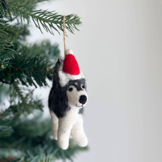 This is a black holiday decorations by Ganapati Crafts Co. called felt ornament - husky with christmas hat in standard