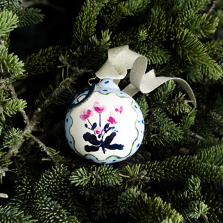This is a blue holiday decorations by Lottie Aldarwish called magenta and blue dots floral customized ornament in standard