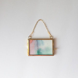 This is a multicolor holiday decorations by Jocelyn Elizabeth called watercolor wash framed ornament 5 in standard