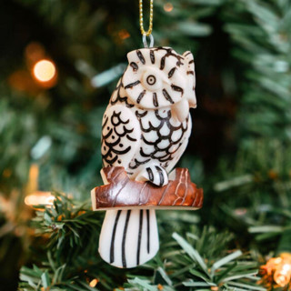 This is a beige holiday decorations by Aahlada Chennupati called mini tagua ivory owl branch ornament in standard