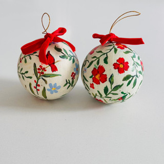 This is a red holiday decorations by Arohika Verma called hand-painted botanical christmas ornaments on off white background – set of 2 in standard