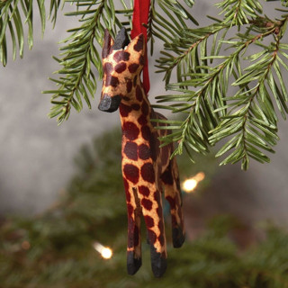 This is a brown holiday decorations by Aahlada Chennupati called painted wood mini giraffe christmas ornament in standard