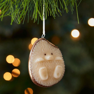 This is a beige holiday decorations by Aahlada Chennupati called mini tagua ivory hedgehog ornament in standard