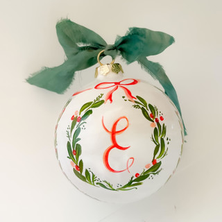 This is a green holiday decorations by Lucrecia Caporale called hand painted botanical wreath customised initial - ceramic ornament in standard