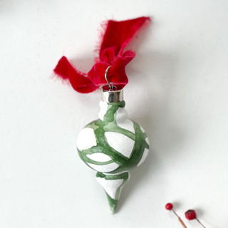 This is a green holiday decorations by Mary Gaspar called green plant cell vintage ornament with red ribbon in standard