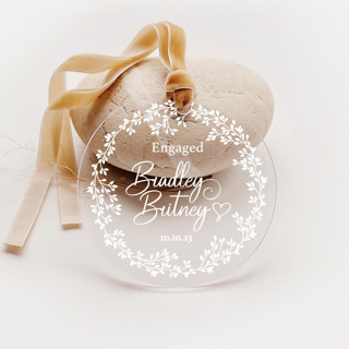 This is a white holiday decorations by Iveta Abolina called personalized acrylic white floral wreath engagement ornament, set of 1 in standard