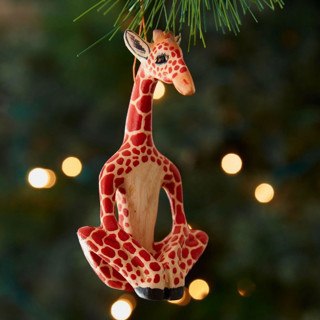 This is a brown holiday decorations by Aahlada Chennupati called painted wood yoga giraffe christmas ornament in standard