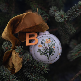 This is a multicolor holiday decorations by Lottie Aldarwish called floral customized ornaments in green and indian yellow in standard