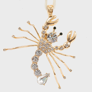 This is a gold holiday decorations by Joanna Buchanan called scorpio hanging ornament in standard