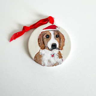 This is a white holiday decorations by Arohika Verma called custom hand-painted pet ornament - santa hat in standard