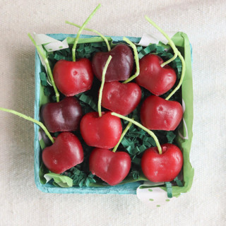 This is a red party decorations by Happy Organics called dark red cherry beeswax birthday candles in standard