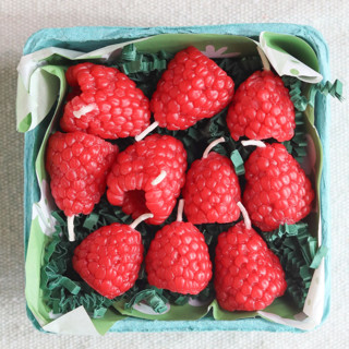 This is a red party decorations by Happy Organics called raspberry beeswax birthday candles in standard