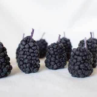 This is a black party decorations by Happy Organics called blackberry beeswax birthday candles in standard