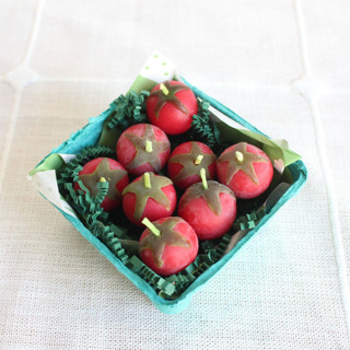 This is a red party decorations by Happy Organics called red cherry tomato beeswax birthday candles in standard