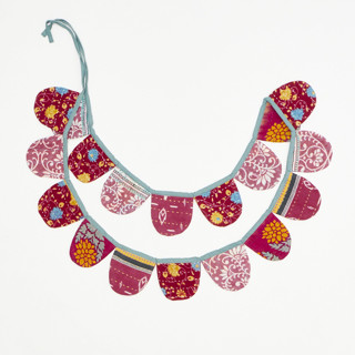 This is a pink party decorations by Anchal called kantha scallop banner - no. 240207 in standard