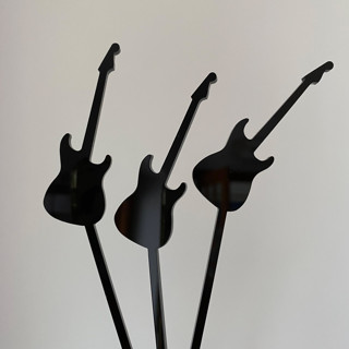 This is a multicolorassorted-colors party decorations by Atomic Kraftworks called guitar stir sticks in standard