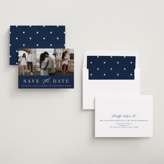 This is a navy foil stamped save the date cards with foil pressed by Andrea Cernin called minimal elegance printing on recycled smooth signature in standard