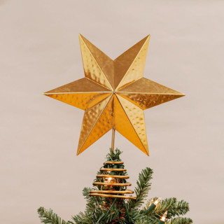 This is a gold holiday decorations by Aahlada Chennupati called large gold star tree topper in standard