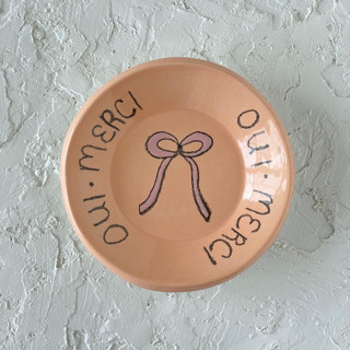 This is a orange decorative objects by Quiet Clementine called french bow round trinket dish in standard