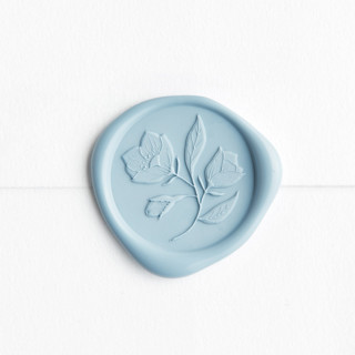 This is a dusty blue wax seals by Minted called wild rose in blue | little north company x artisaire (pack of 25) in standard