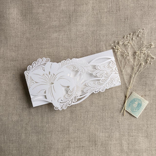 This is a white belly bands by Ivory Invitations called white lily floral laser cut belly band for 5x7 inch invitation | pack of 10 in standard