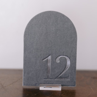 This is a gray table numbers by Velvet Raptor called double sided table number - arch - dove in standard