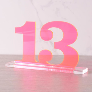 This is a pink table numbers by Em and Me Studio called clarendon table numbers, fluorescent pink in standard