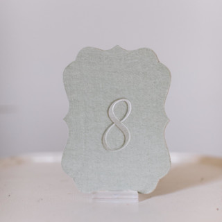 This is a green table numbers by Velvet Raptor called seagreen script scroll table number in standard