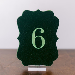 This is a green table numbers by Velvet Raptor called double sided table number - scroll - emerald in standard