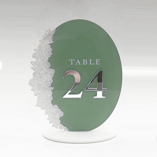 This is a clear table numbers by Artifacture called oval acrylic table numbers w silver mirror numbers in standard