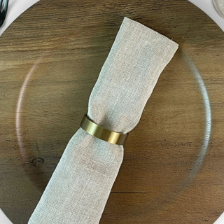 This is a green wedding decor by Corduroy Effect called brass color crescent napkin rings, set of 4 in standard