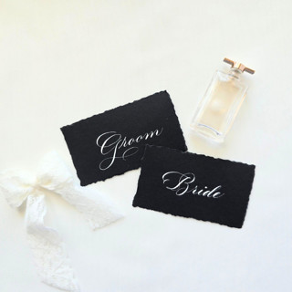 This is a black wedding place cards by Inkspiringletters called custom calligraphy place cards- black hand-torn paper- set of 10 in standard