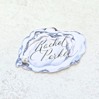 This is a white wedding place cards by Inkspiringletters called watercolor oyster with white pearl place card- personalized with calligraphy- set of 10 in standard