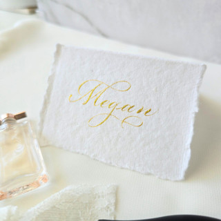 This is a white wedding place cards by Inkspiringletters called custom calligraphy place cards- tent- style handmade paper- set of 10 in standard