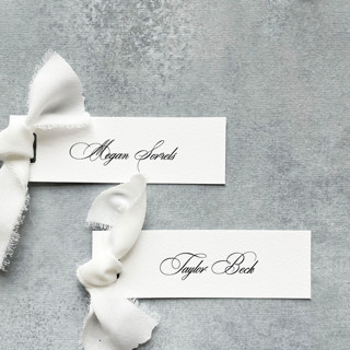 This is a white wedding place cards by Cotton and Bow called slim place cards with white bow | set of 10 | custom text in standard