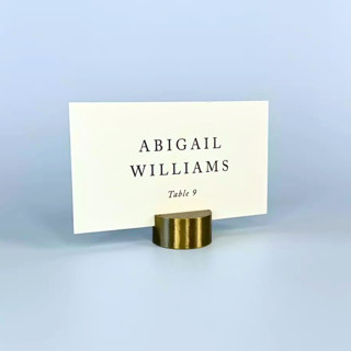 This is a brass place card holders by Corduroy Effect called brass color circle place card holder, set of 25 in standard