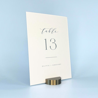 This is a brass place card holders by Corduroy Effect called brass color round table number holder, set of 5 in standard