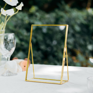 This is a gold place card holders by Lea Li called brass and glass gold vertical 5x7" card holder in standard