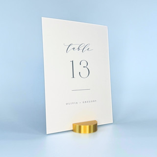 This is a gold place card holders by Corduroy Effect called gold color round table number holder, set of 5 in standard