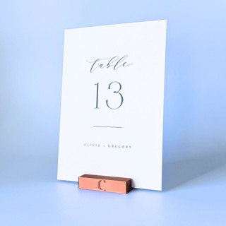 This is a copper place card holders by Corduroy Effect called personalized copper color rectangle table number holders, set of 5 in standard