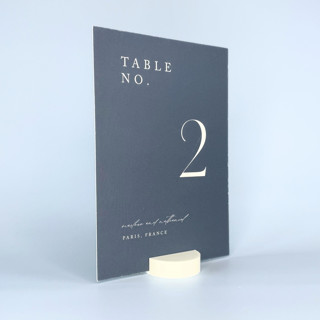 This is a white place card holders by Corduroy Effect called white round table number holder, set of 5 in standard