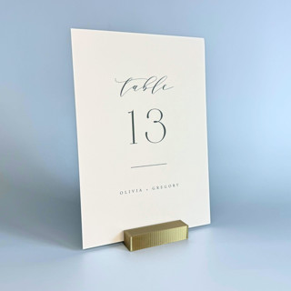 This is a gold place card holders by Corduroy Effect called brass color rectangle table number holder, set of 5 in standard