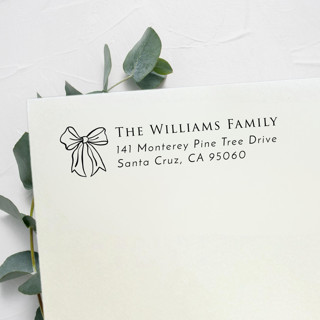 This is a black address labels by Samantha Malvey called luxe bow stamp | self inking return address stamp in standard