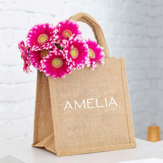 This is a white wedding day of favors by Veronica Esquino called medium personalized bridesmaid gift bags in standard
