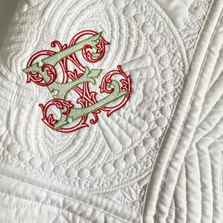 This is a white throw blankets by Virginia Marcello called heirloom personalized baby quilt in standard